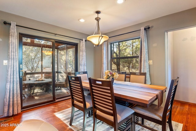 dining space with recessed lighting, wood finished floors, visible vents, and baseboards