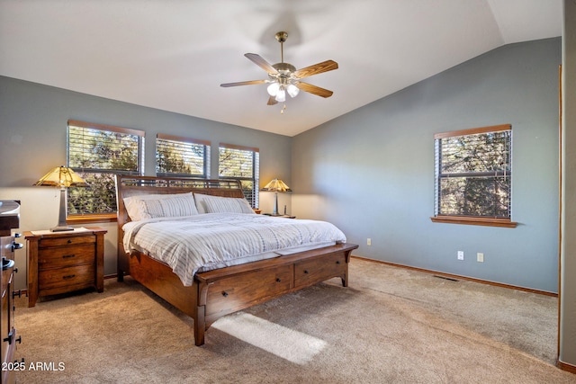 carpeted bedroom with visible vents, ceiling fan, baseboards, and vaulted ceiling