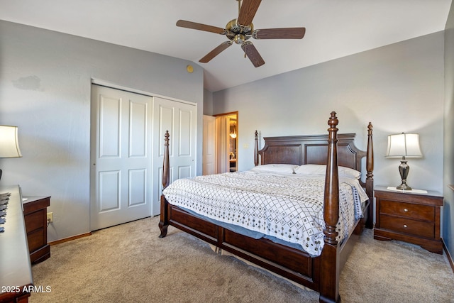 carpeted bedroom featuring a closet, baseboards, a ceiling fan, and lofted ceiling