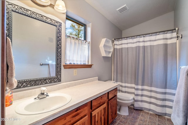 bathroom featuring vanity, a shower with shower curtain, visible vents, vaulted ceiling, and toilet