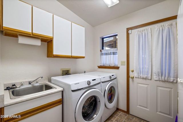 laundry area featuring cabinet space, washer and dryer, and a sink