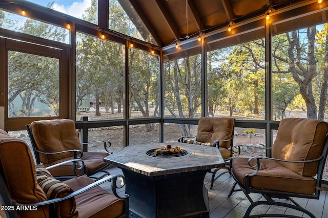 sunroom featuring lofted ceiling