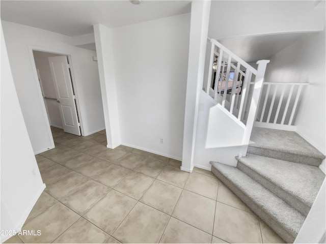 staircase with tile patterned floors