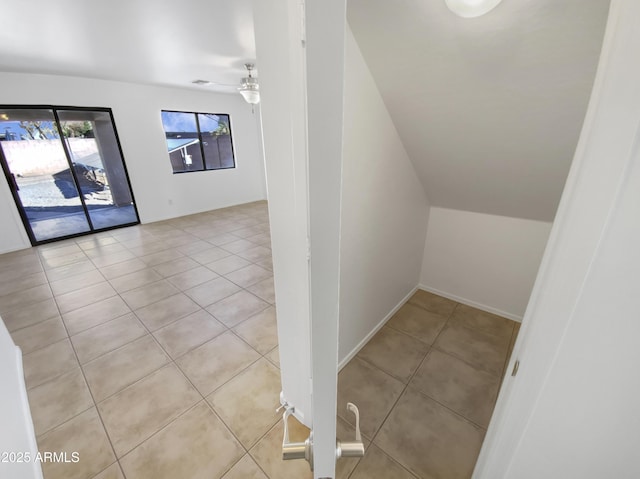 interior space with ceiling fan and tile patterned flooring