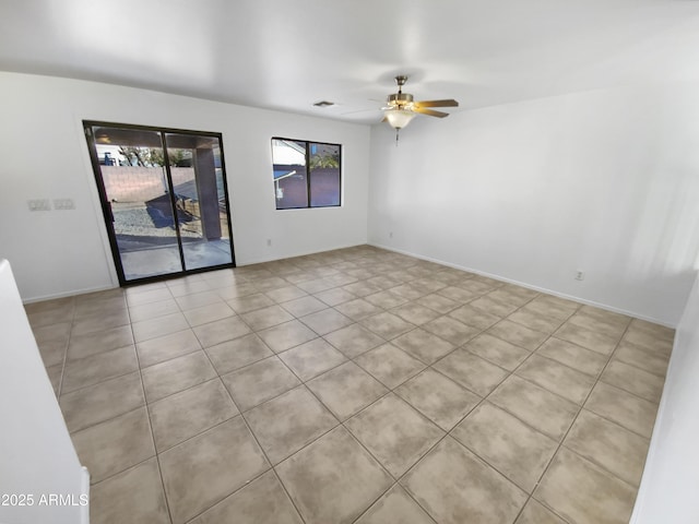 spare room featuring ceiling fan and light tile patterned floors