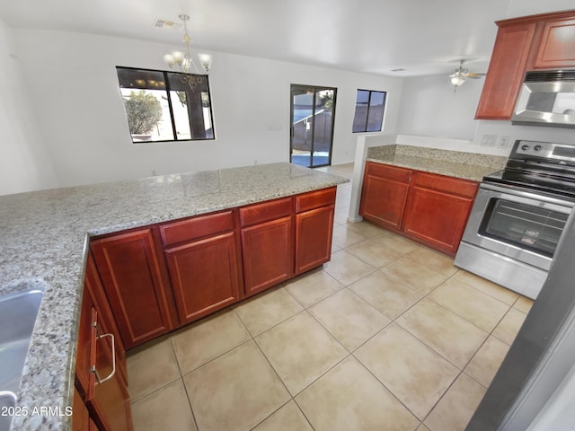 kitchen with light tile patterned floors, stainless steel appliances, light stone countertops, pendant lighting, and ceiling fan with notable chandelier