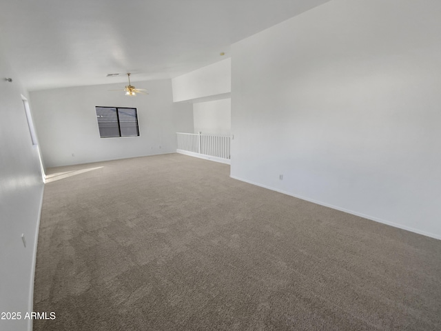 carpeted empty room featuring vaulted ceiling and ceiling fan