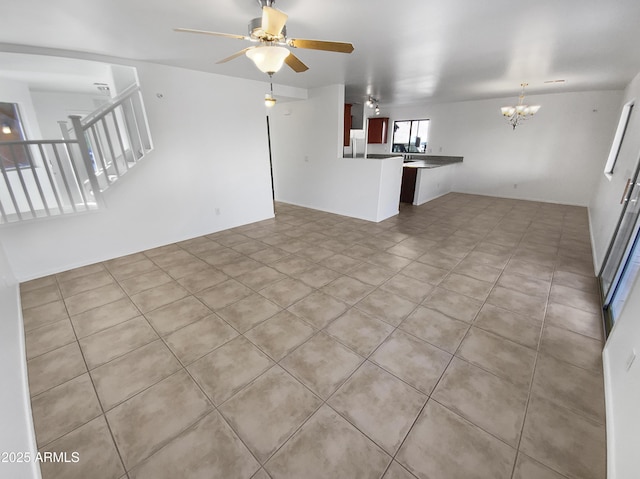 unfurnished living room with light tile patterned floors and ceiling fan with notable chandelier