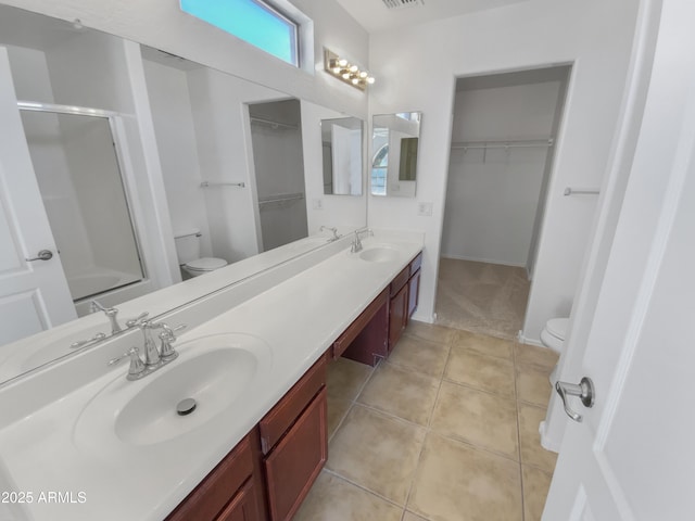 bathroom with toilet, tile patterned floors, an enclosed shower, and vanity