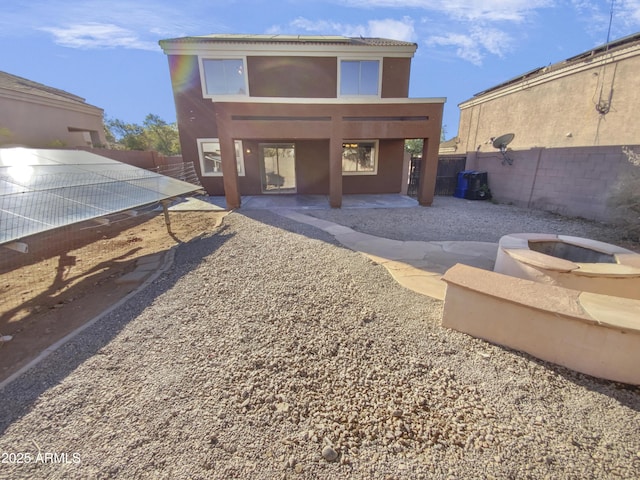 rear view of house with a patio area and a fire pit