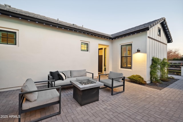 view of patio / terrace with an outdoor living space with a fire pit