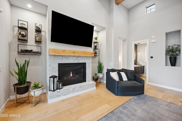 living room with hardwood / wood-style flooring and a towering ceiling