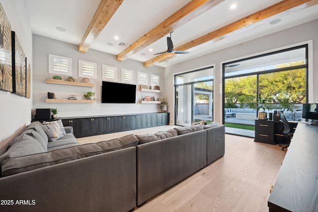 living room with beamed ceiling and light hardwood / wood-style flooring