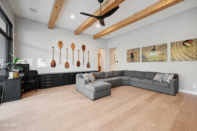 living room with beamed ceiling, ceiling fan, and light wood-type flooring