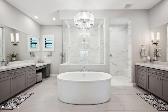 bathroom featuring vanity and independent shower and bath