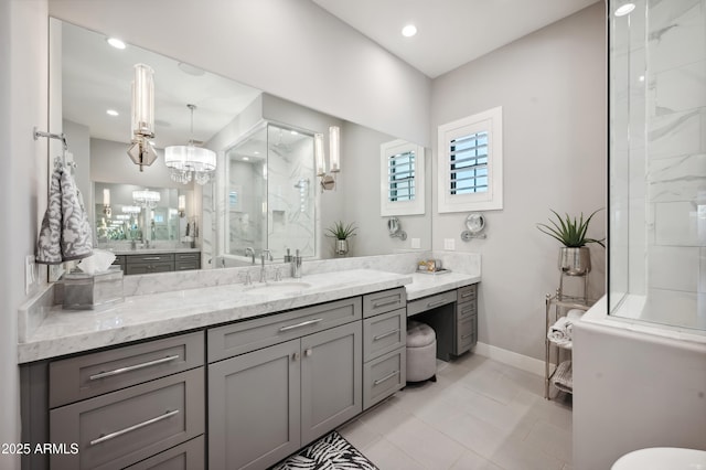 bathroom featuring a shower with door, vanity, tile patterned floors, and a chandelier