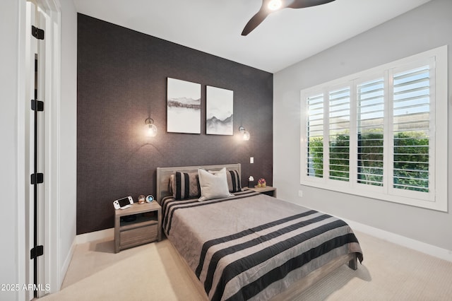 bedroom featuring light colored carpet and ceiling fan