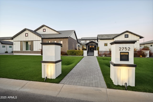 modern farmhouse style home with a lawn