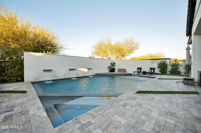 view of swimming pool with a patio and pool water feature