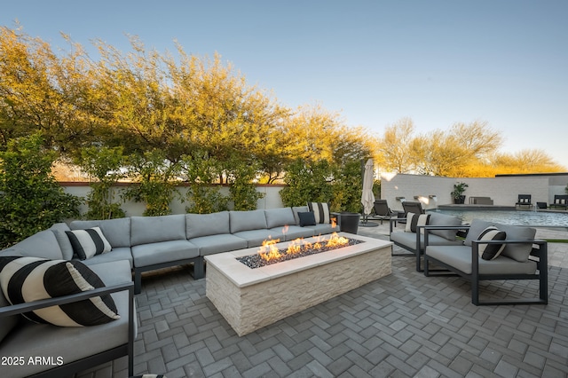 view of patio / terrace featuring an outdoor living space with a fire pit