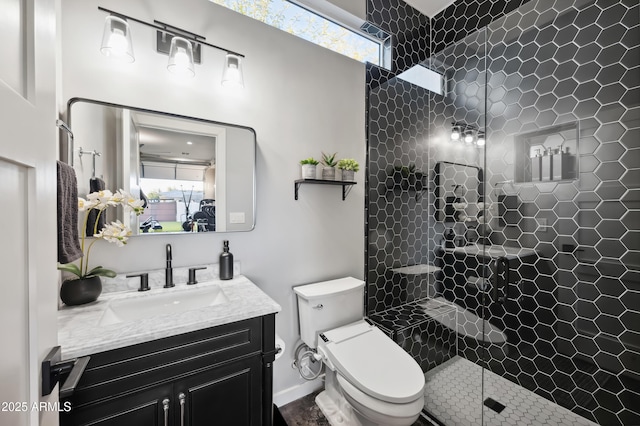 bathroom with vanity, toilet, and a tile shower