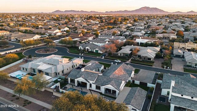 aerial view at dusk featuring a mountain view