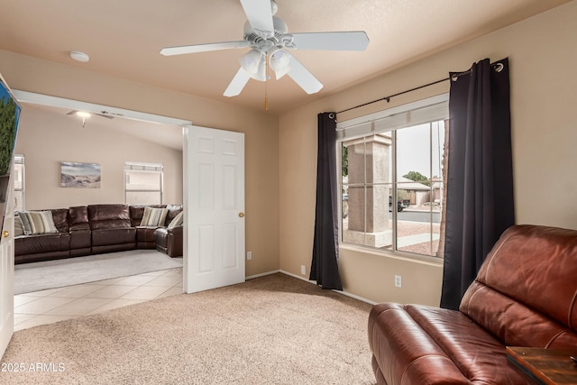 sitting room with tile patterned flooring, baseboards, a ceiling fan, and carpet floors