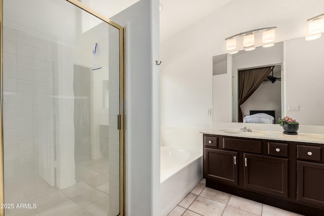 bathroom with tile patterned floors, a garden tub, connected bathroom, a shower stall, and vanity