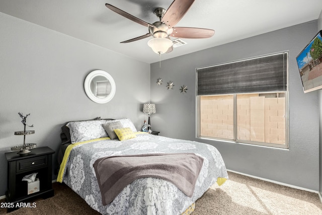 bedroom featuring visible vents, a ceiling fan, baseboards, and carpet floors