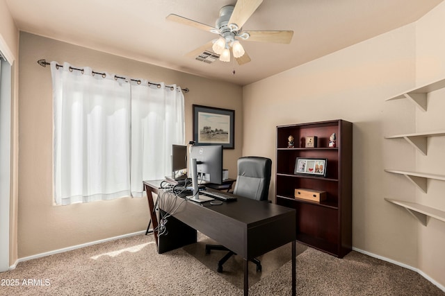 office space featuring visible vents, baseboards, carpet flooring, and a ceiling fan