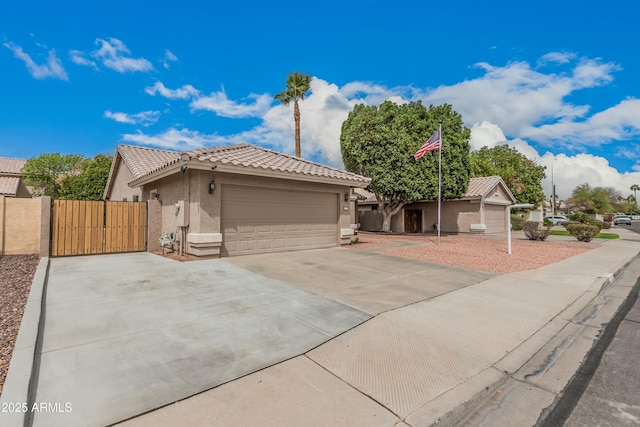 single story home with stucco siding, driveway, a gate, a tile roof, and a garage