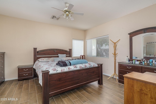 bedroom with wood tiled floor, visible vents, baseboards, and a ceiling fan