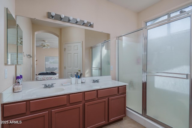 bathroom featuring a sink, a shower stall, ensuite bath, and ceiling fan
