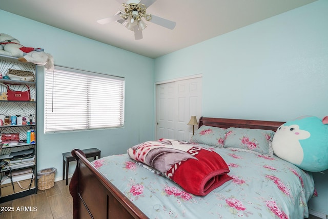 bedroom with a ceiling fan, a closet, and wood finished floors