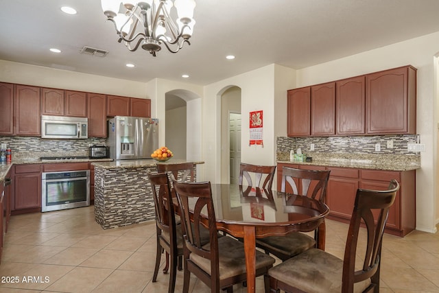 dining space featuring visible vents, a notable chandelier, recessed lighting, and light tile patterned floors