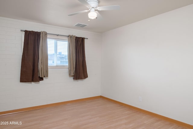 unfurnished room featuring visible vents, baseboards, light wood-style flooring, and a ceiling fan