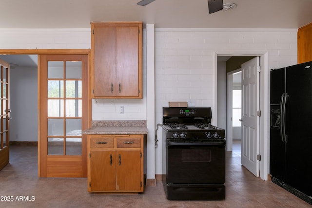 kitchen featuring tasteful backsplash, black appliances, and light countertops