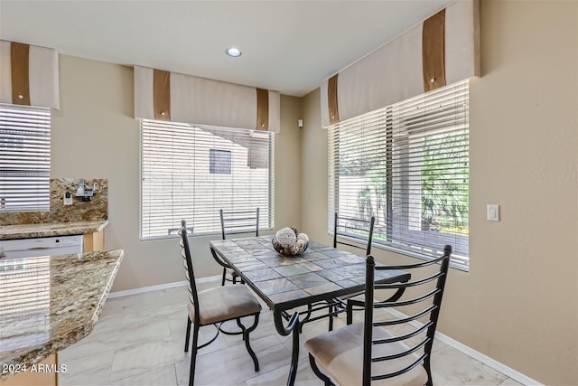 tiled dining space with a wealth of natural light