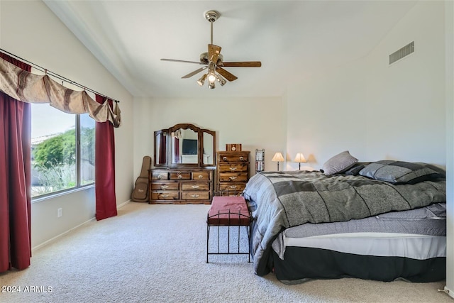 carpeted bedroom featuring vaulted ceiling and ceiling fan