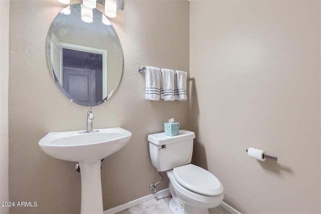 bathroom featuring tile floors and toilet