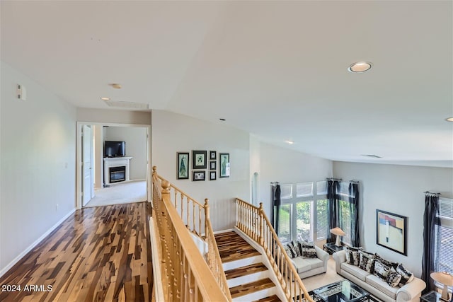 hall with hardwood / wood-style floors and lofted ceiling