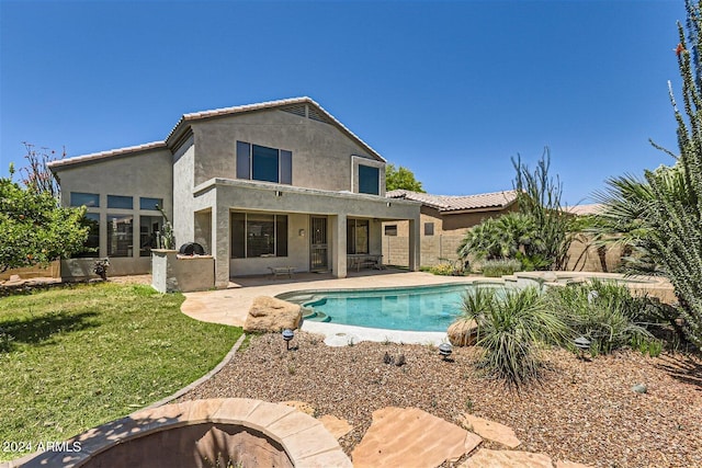 view of swimming pool featuring a lawn and a patio