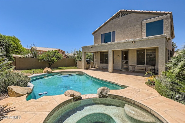 view of swimming pool with a patio area and an in ground hot tub