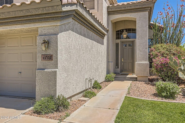 view of exterior entry with a garage