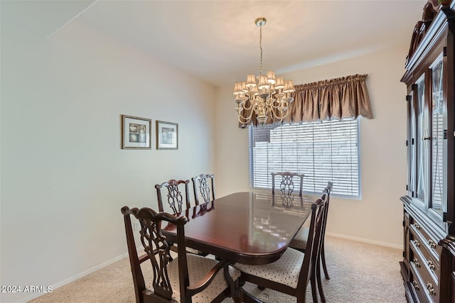 carpeted dining area featuring a chandelier