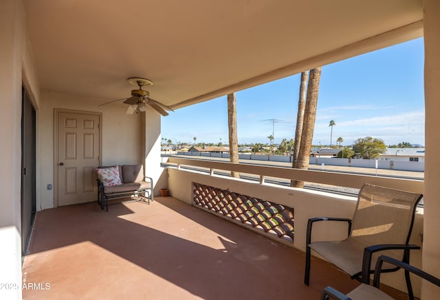 view of patio / terrace with a balcony and ceiling fan