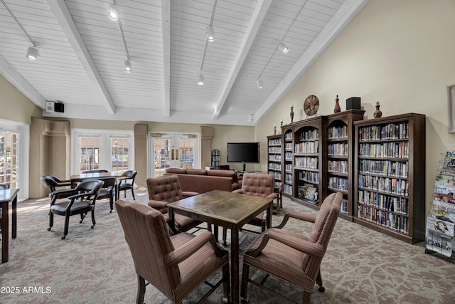 dining room with rail lighting, wood ceiling, and vaulted ceiling with beams