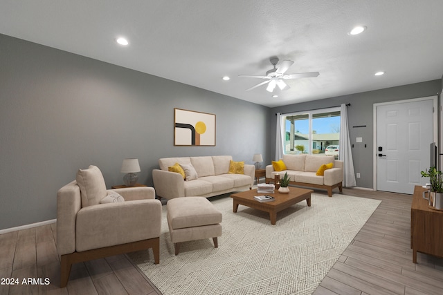 living room with ceiling fan and light hardwood / wood-style floors