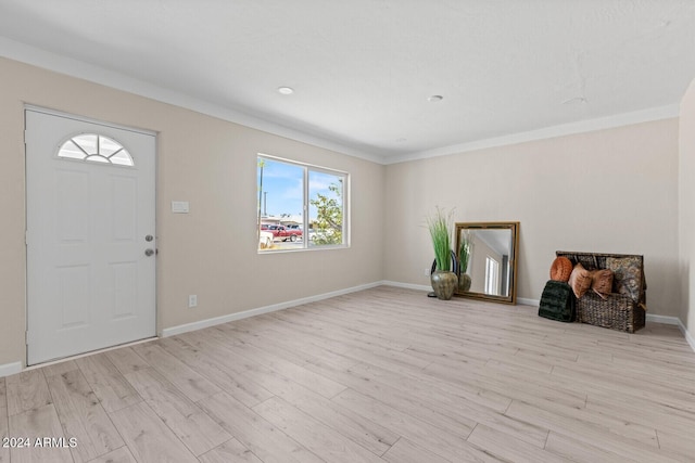 foyer entrance with baseboards and light wood finished floors