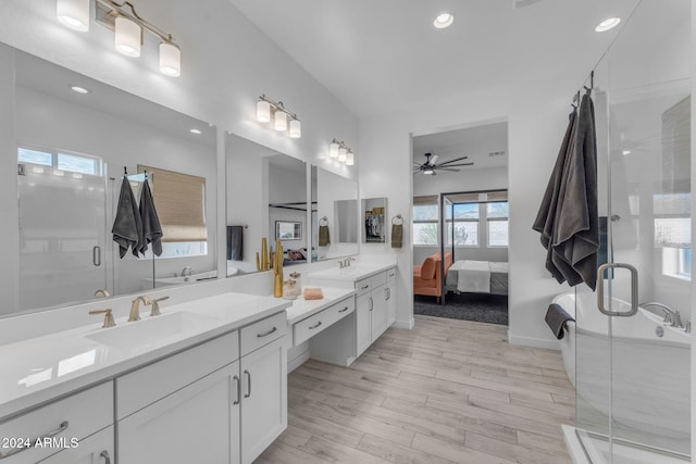 bathroom featuring ceiling fan, a healthy amount of sunlight, and wood-type flooring